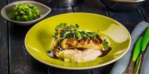 cod fillet with mashed potatoes, sauce and herbs