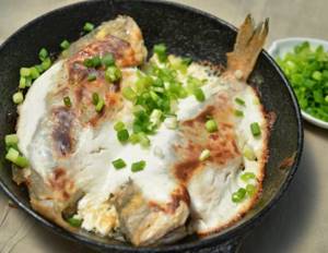 Crucian carp with sour cream in a frying pan