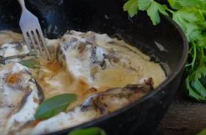 carp in sour cream in a frying pan
