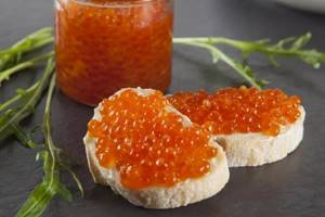 red caviar on pieces of bread and in a jar