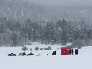 Fishermen&#39;s camp and their snowmobiles