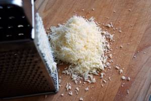 Parmesan cheese is grated to make batter.