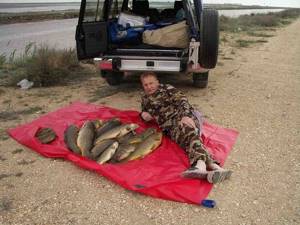 Fisherman lies with a bunch of fish