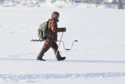 Fisherman with an ice auger