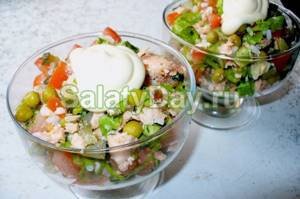 Salad with boiled fish, squid, cheese and crab sticks