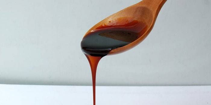 Beetroot molasses in a spoon