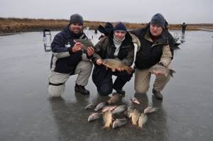 Three fishermen on winter fishing