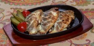 three carp carcasses with pickled cucumber and tomato