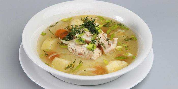 Fish soup with millet and pieces of salmon